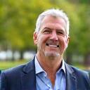 David, 48, looking healthy and vibrant, with a backdrop of a quiet park.
