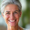 Happy woman smiling, after achieving wellness goals.